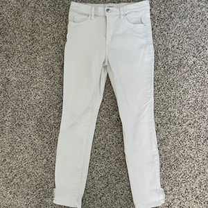 White skinny jeans with ripped detail on ankle